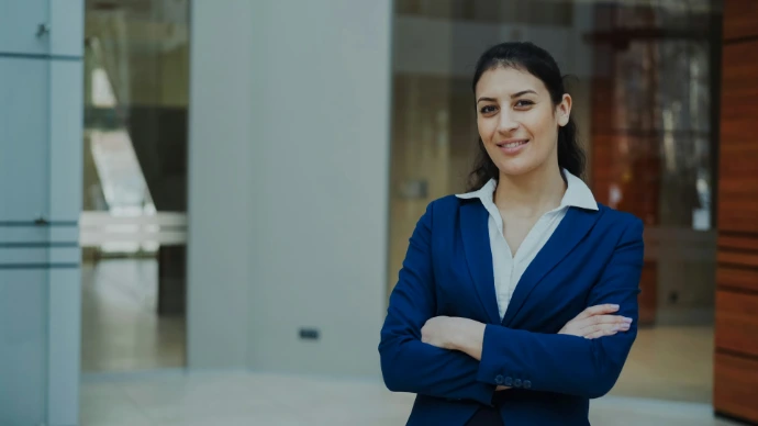 A confident businesswoman in a blue suit smiles.